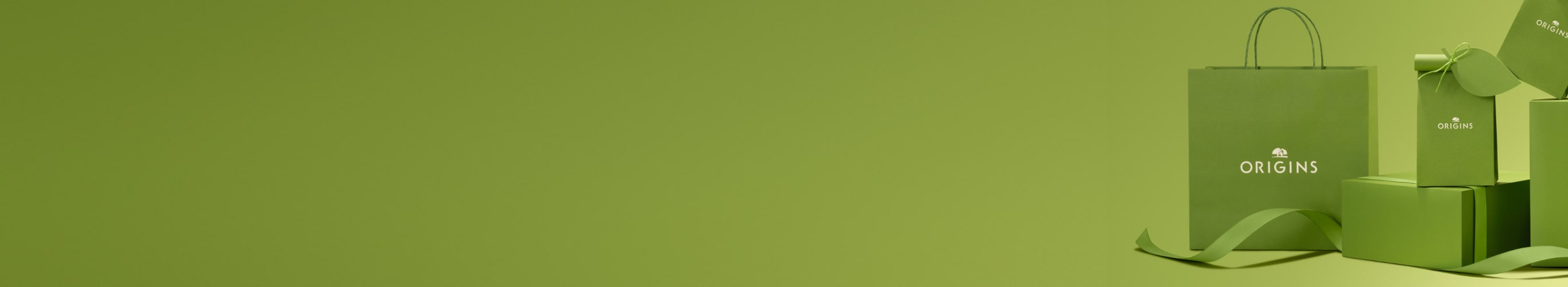 beige background with brown gift boxes with green ribbon