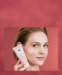 woman holding the original skin mask with a heart shape on her cheek