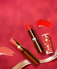 lipsticks on rose background