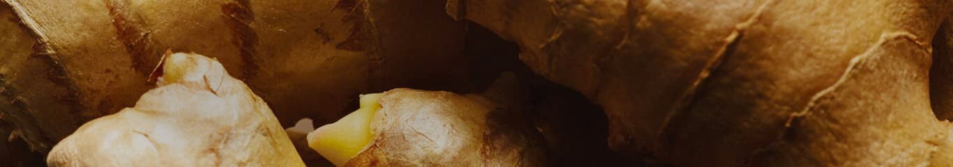 close up of raw ginger of which scent is contained in Origins Ginger body products