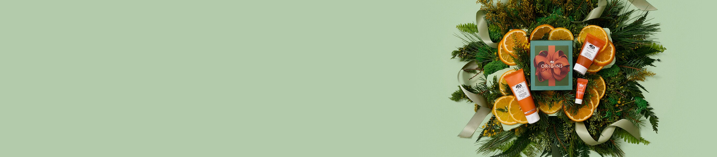 white background with brown gift boxes and dark green ribbon 