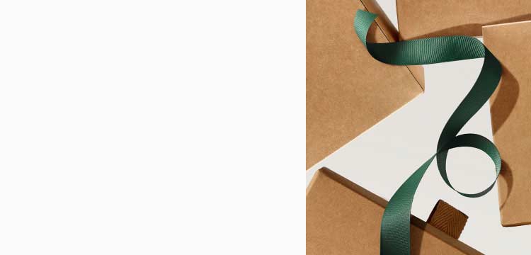 white background with brown gift boxes and dark green ribbon 